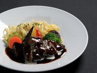 Domestic beef stew with steamed vegetables and noodles