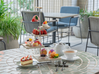 Strawberry afternoon tea with spring flowers fluttering about